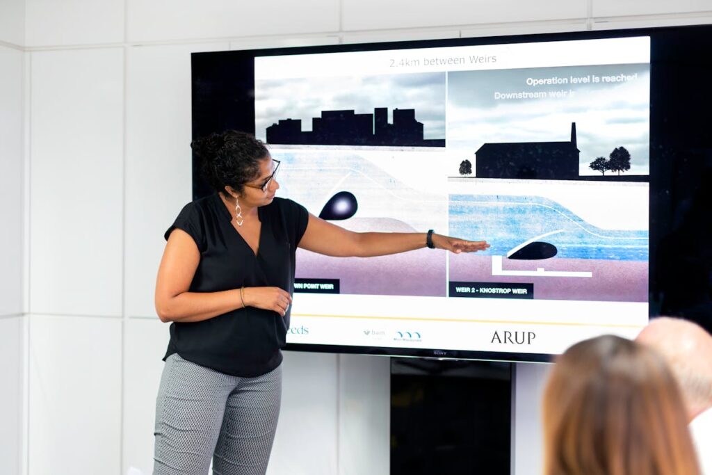 A woman engineer presents a project on weir construction in an office setting.